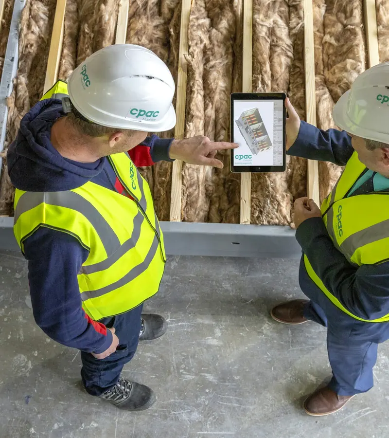 Engineers reviewing a maintenance inspection report on a tablet