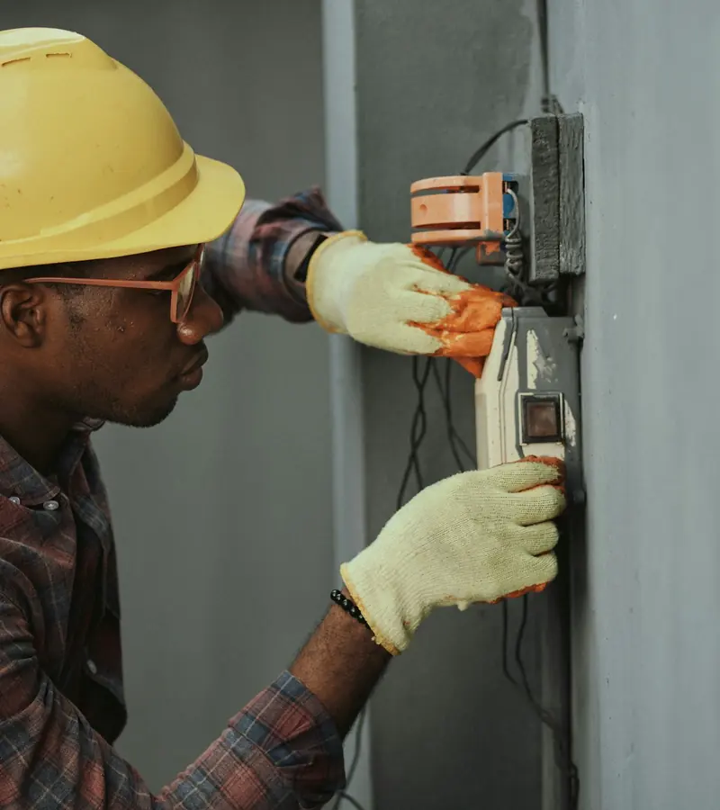 Electrician installing electrical wiring on site