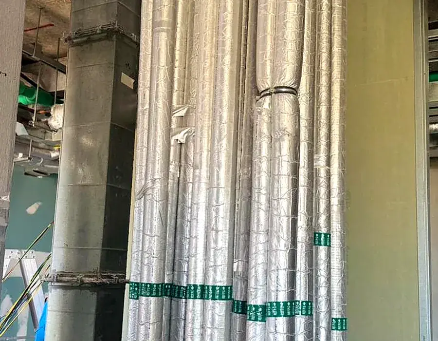 Insulated HVAC riser ductwork in a staff accommodation building